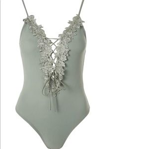 Green bodysuit with floral embedding